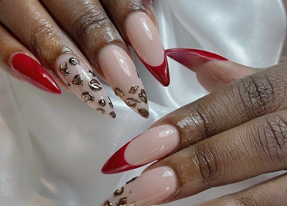 Elegant nail art with red tips and gold details at Cosmo Nails & Beauty, Auckland, Auckland, NZ.
