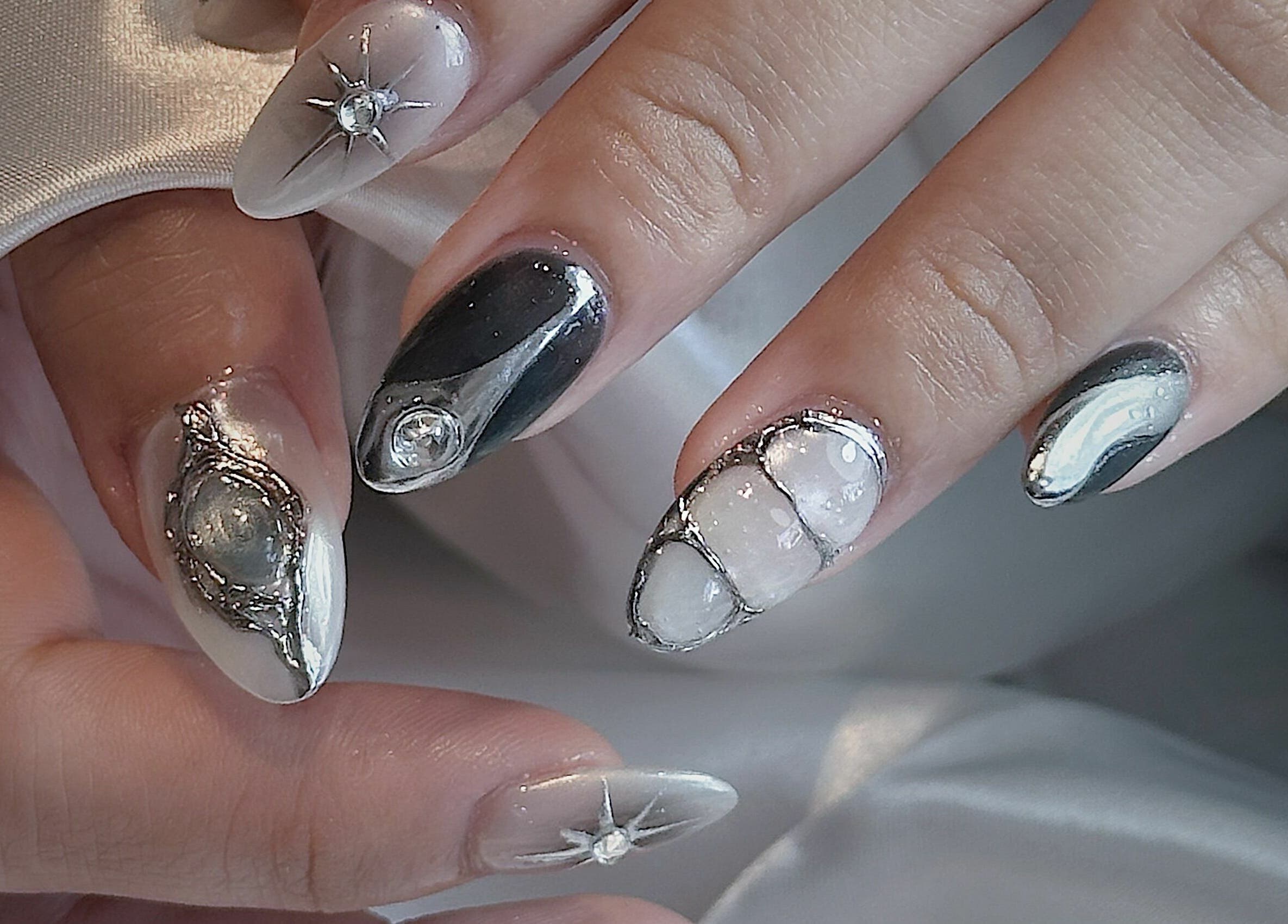 Intricate galactic nail art at Cosmo Nails & Beauty, Auckland, NZ, showcasing unique gemstone and silver designs.