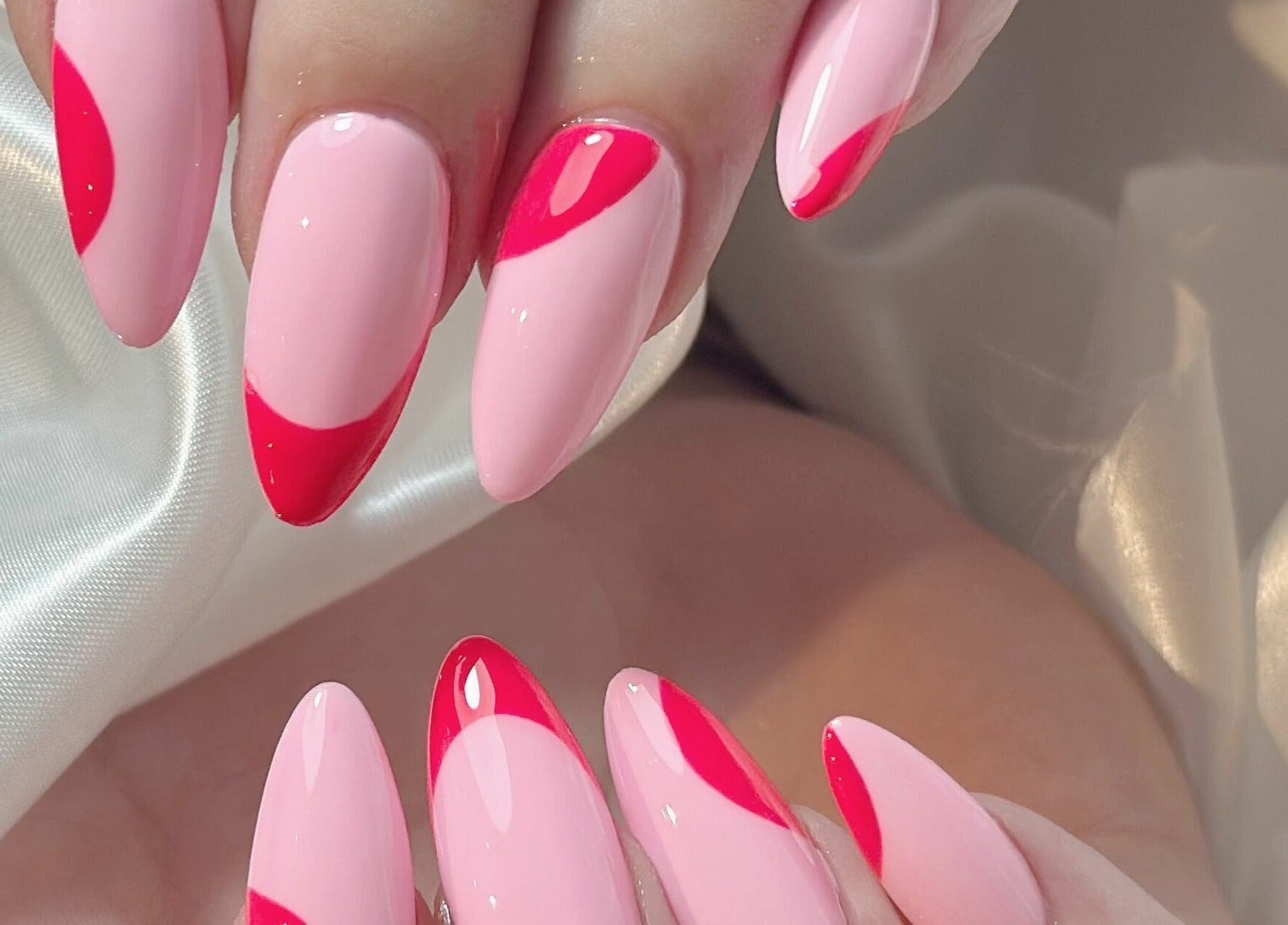 Stylish pink nail design with red accents at Cosmo Nails & Beauty, Auckland, Auckland, NZ.