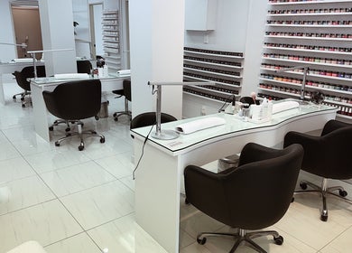 Chic salon at Five Star Nails Mission Bay, Auckland, NZ, with modern nail stations and polish display.