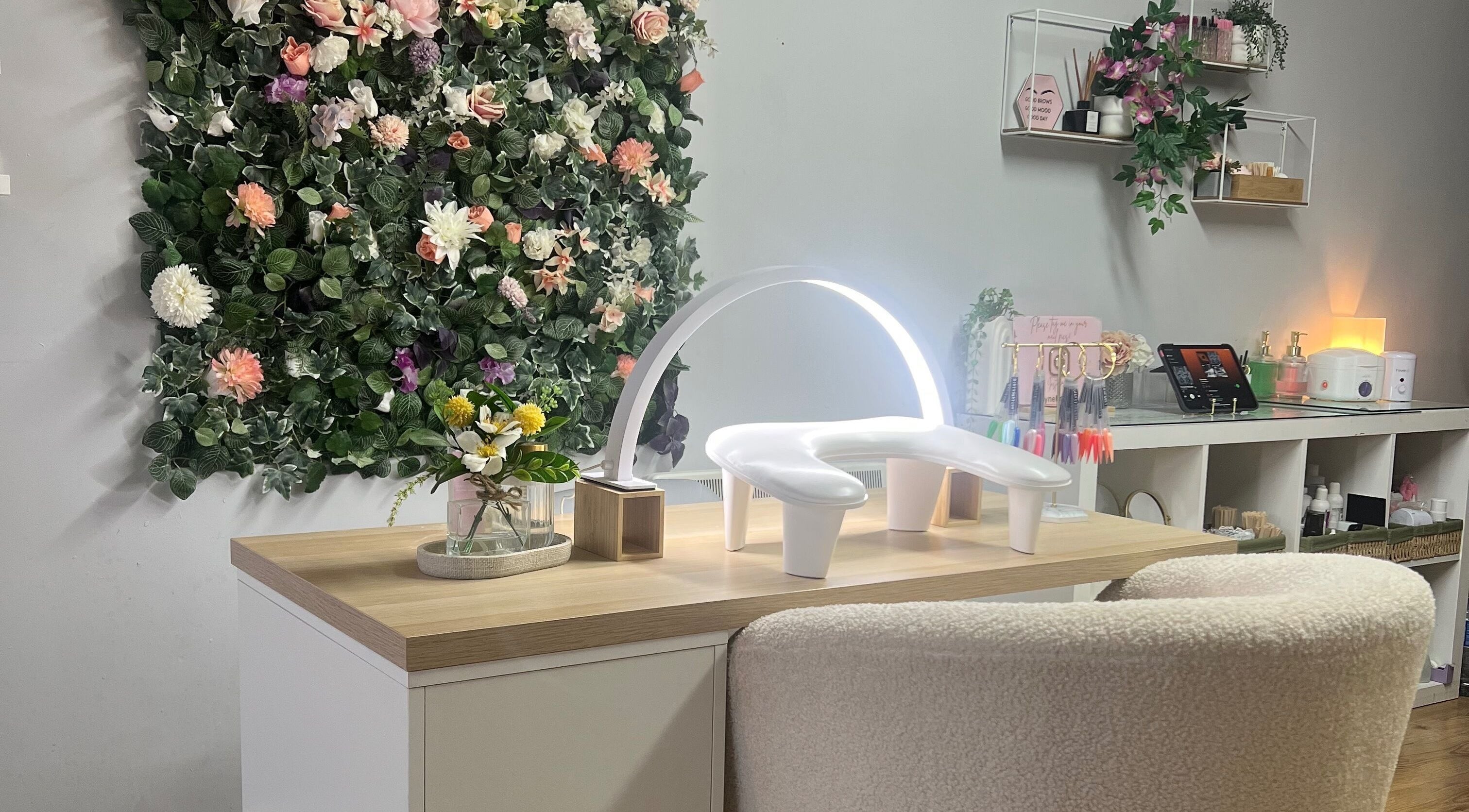 Elegant manicure station at Fynebeauty in Dublin, County Dublin, IE with floral wall art and organized workspace.