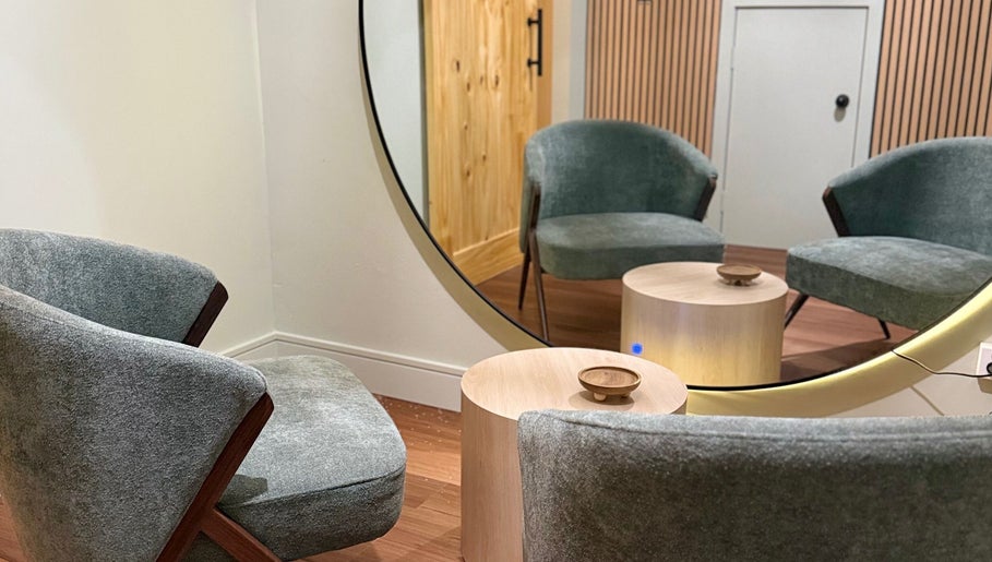 Cozy seating area at Lift Your Soul Head Spa in Stuart Park, Northern Territory, AU with modern chairs and mirror.