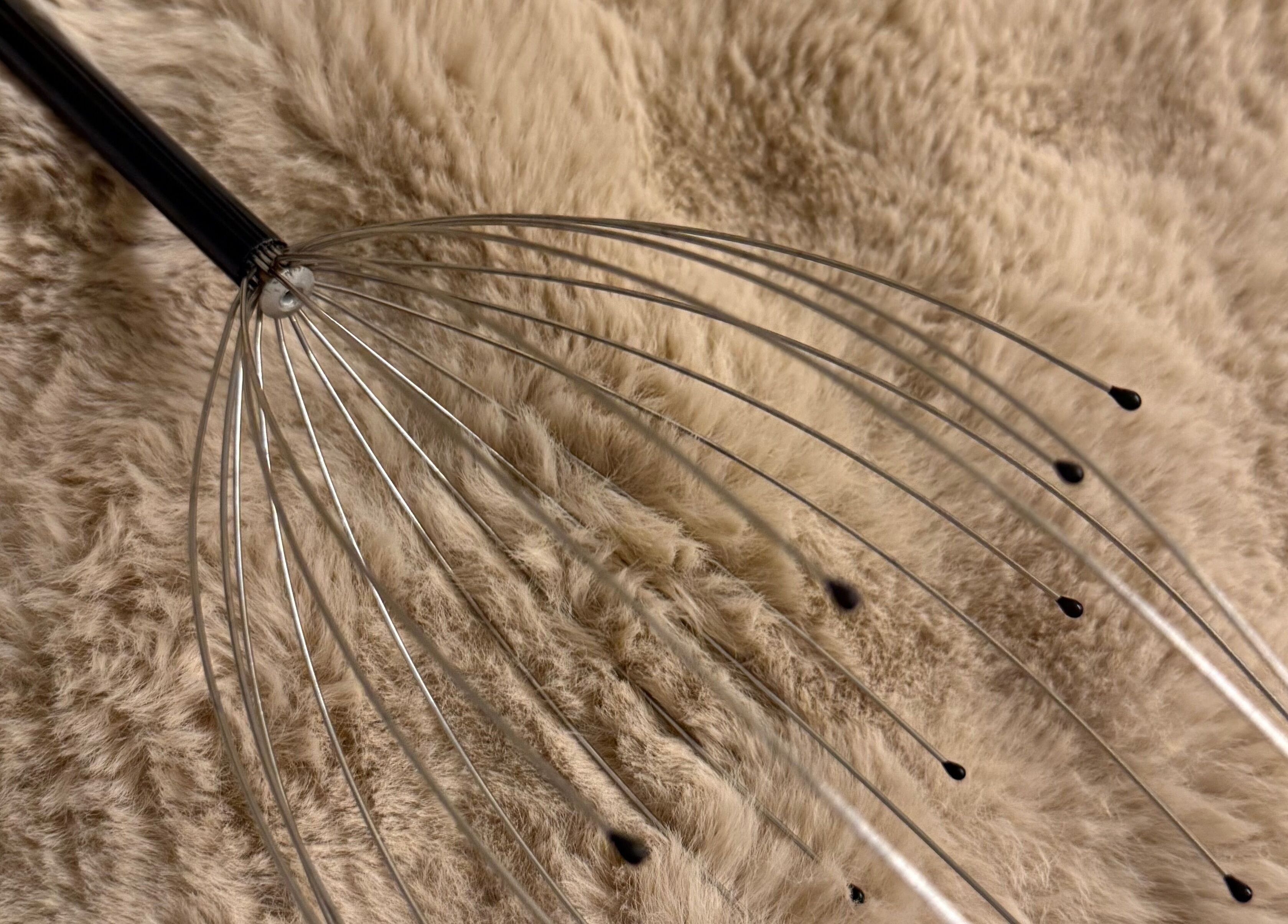 Metal head massager tool on plush surface at Lift Your Soul Head Spa, Katherine South, Northern Territory, AU.