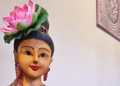 Wooden statue with lotus flower in Breeze Thai Massage & Spa, Poole, England, GB.