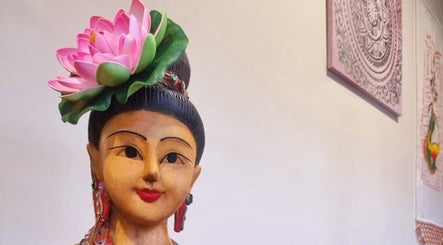 Wooden statue with lotus flower in Breeze Thai Massage & Spa, Poole, England, GB.