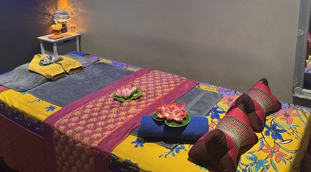 Colorful massage room at Breeze Thai Massage & Spa in Poole, England, GB, showcasing relaxation and elegance.