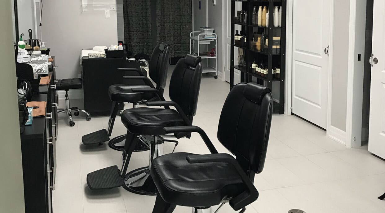 Chic salon interior at Grand Park Spa Laser and Salon, Mississauga, Ontario, CA featuring stylish black chairs.