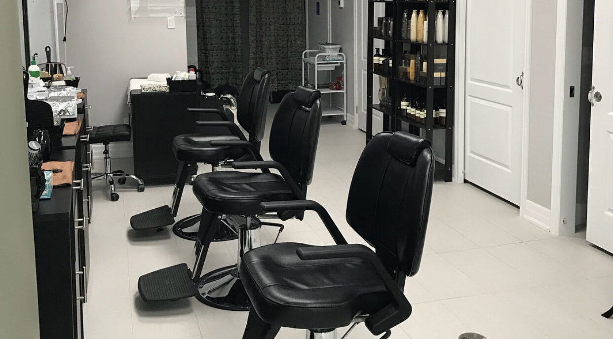 Chic salon interior at Grand Park Spa Laser and Salon, Mississauga, Ontario, CA featuring stylish black chairs.