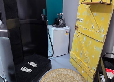 Cozy wellness space at Treat Yourself Beautifully, Clermont, Queensland, AU, featuring a yellow rustic door and modern amenities.