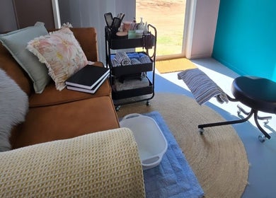 Relaxing lounge area with cozy decor at Treat Yourself Beautifully, Clermont, Queensland, AU.