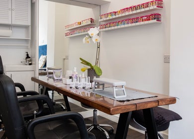 Effulgent Beauty's manicure station in London, United Kingdom. Featuring sleek design and vibrant nail polish display.
