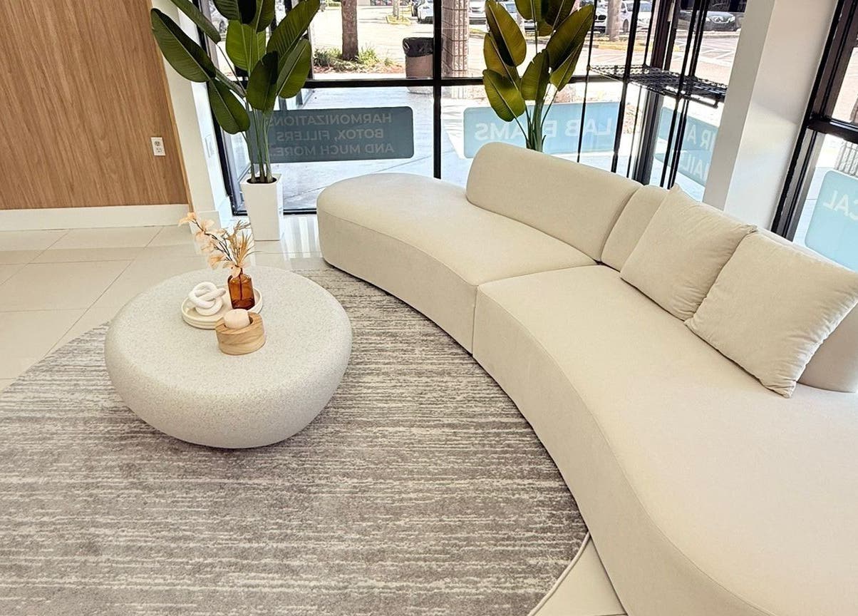 Chic waiting area in BG Studio Salon, Coconut Creek, Florida, US with modern sofa and decor.