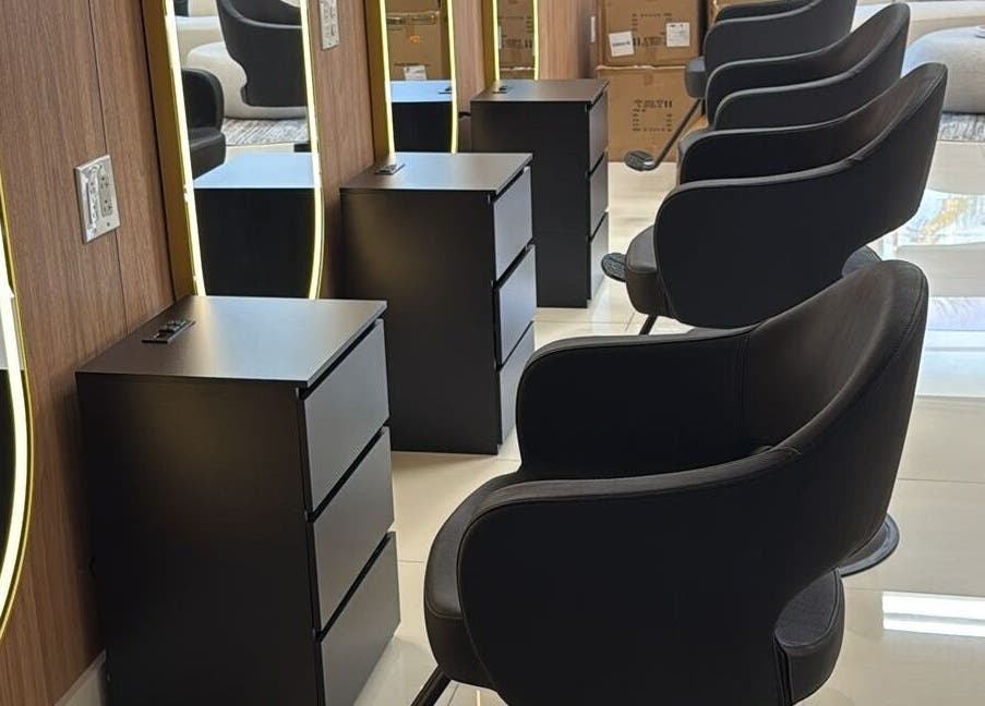 Chic styling area at BG Studio Salon, Coconut Creek, Florida, US with sleek chairs and illuminated mirrors.