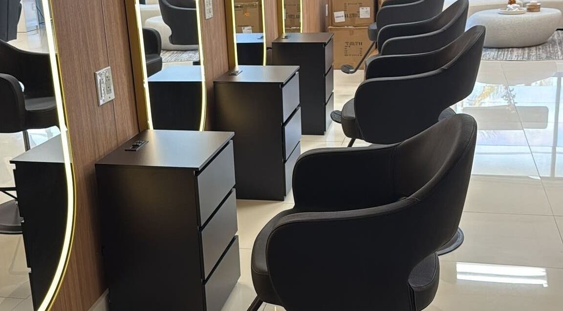 Chic styling area at BG Studio Salon, Coconut Creek, Florida, US with sleek chairs and illuminated mirrors.