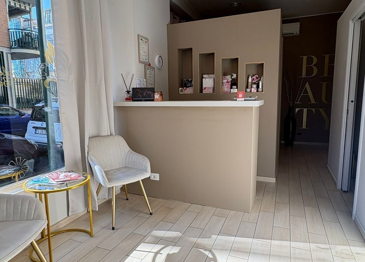 Interno L'angolo Del Benessere a Torino, accogliente area reception con sedie e tavolino.