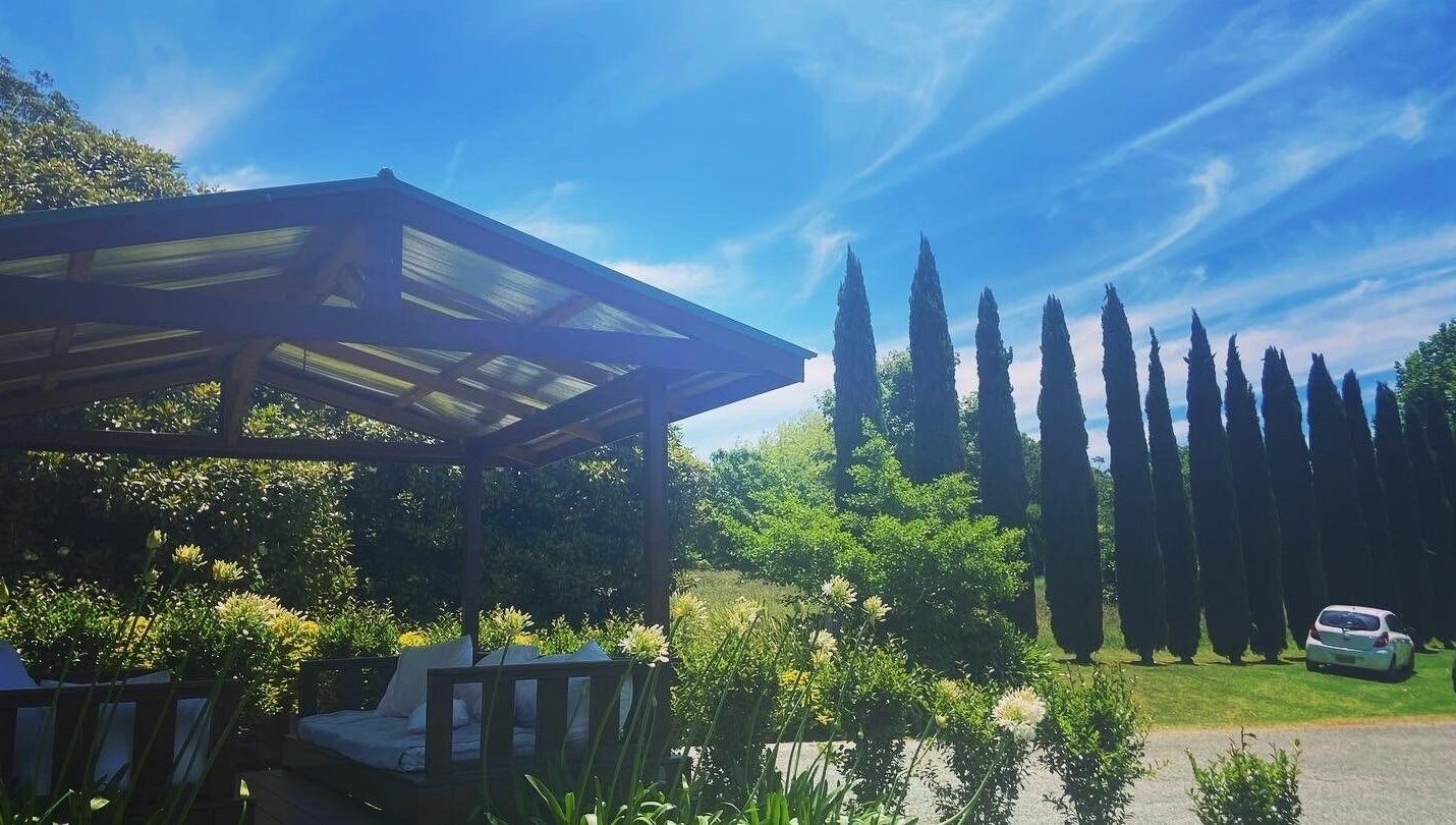 Relaxing outdoor lounge at Getaway Day Spa, Mt Tamborine, Queensland, AU surrounded by lush greenery.