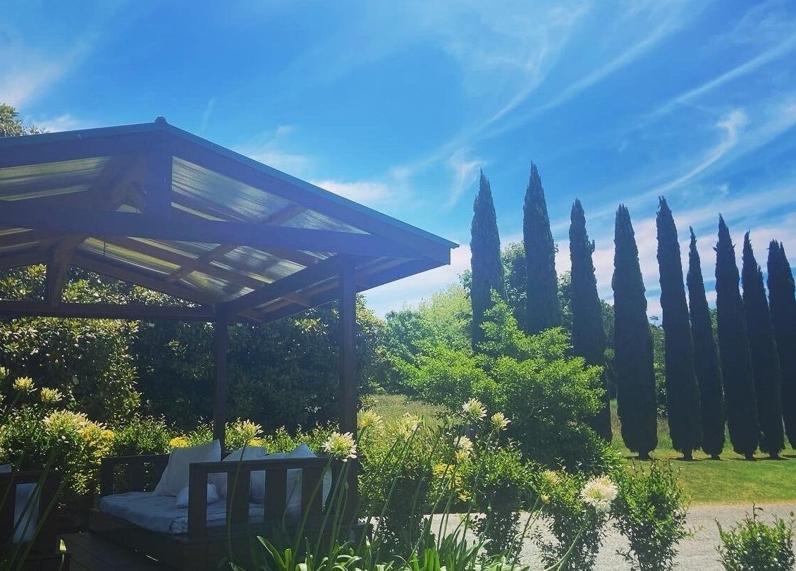 Relaxing outdoor lounge at Getaway Day Spa, Mt Tamborine, Queensland, AU surrounded by lush greenery.