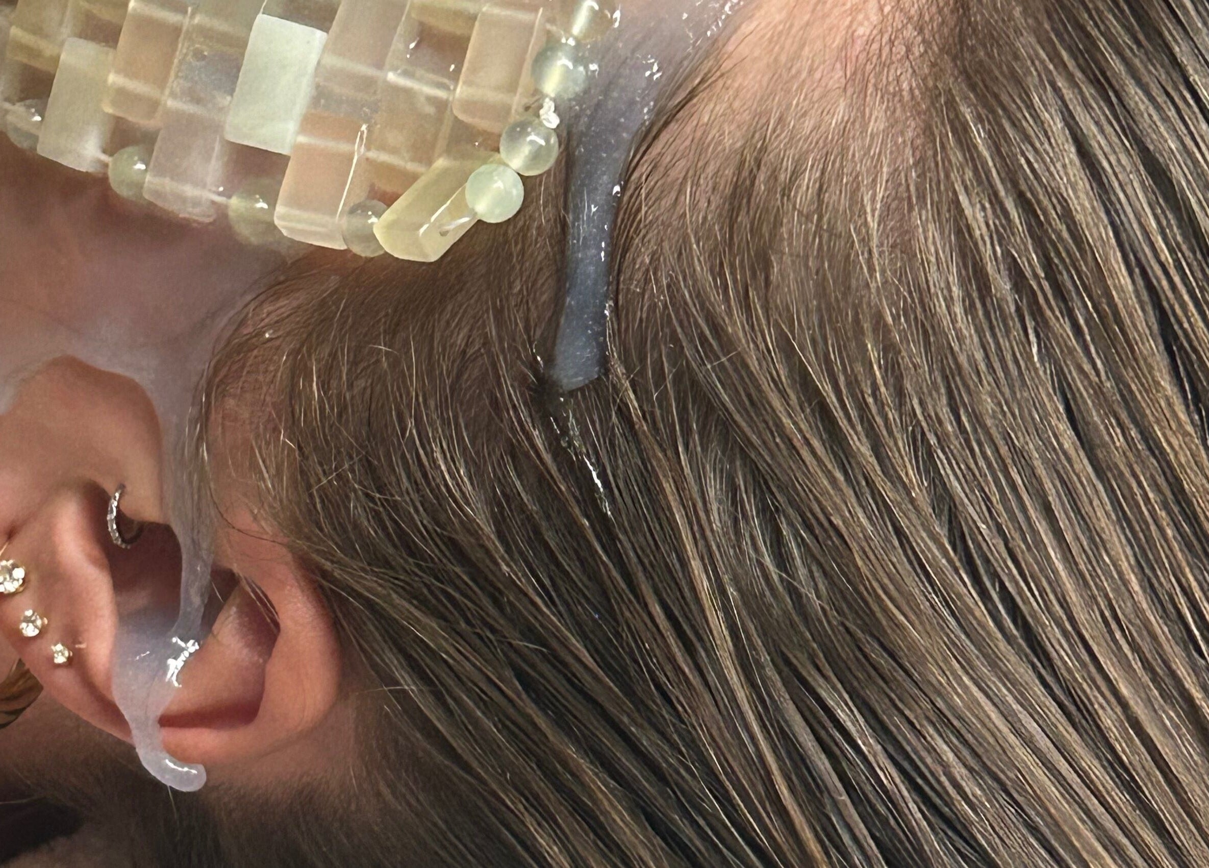 Hair treatment session at Aleestheticss, Laval, Québec, CA, showcasing rejuvenation with oil application.