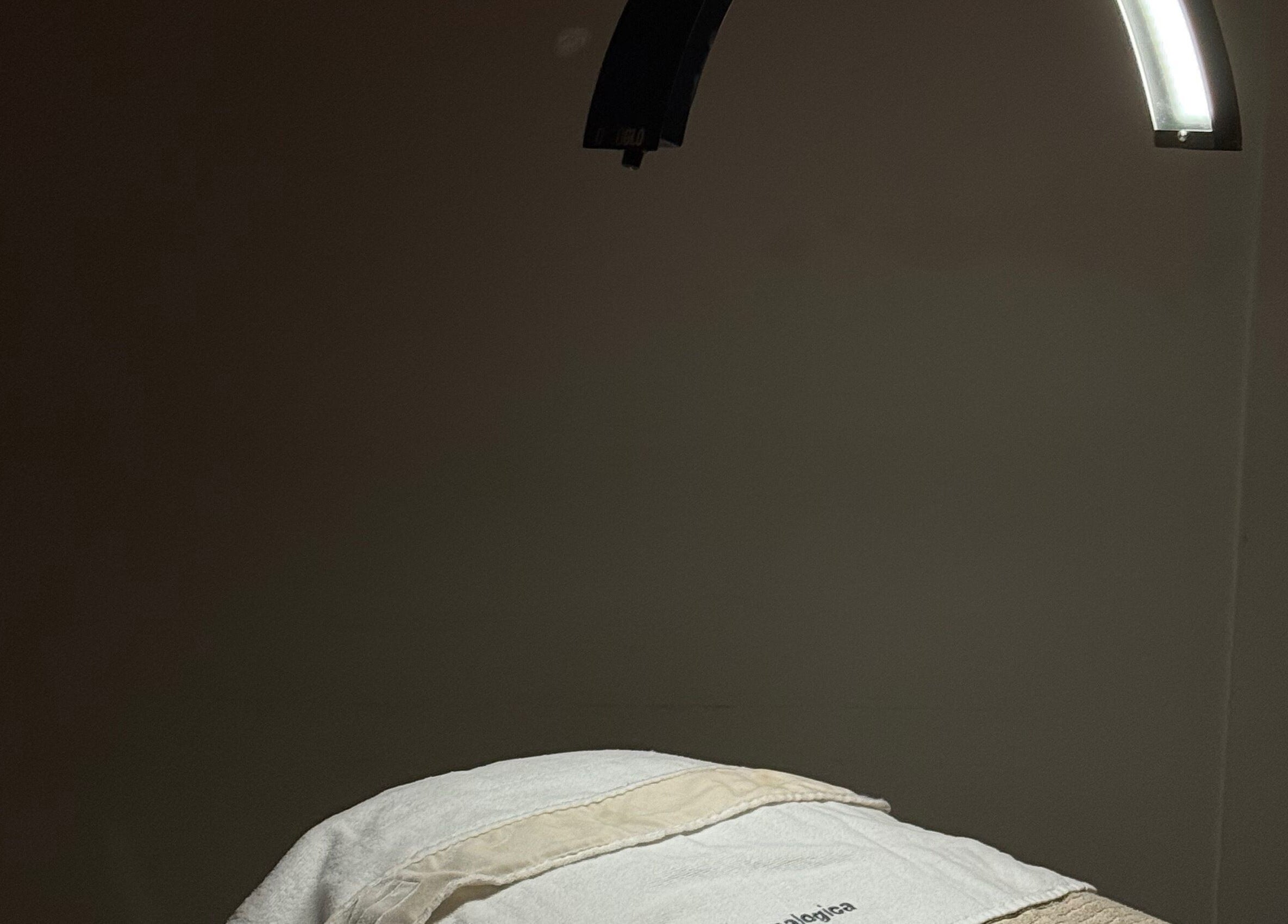 Treatment room at Aleestheticss, Laval, Québec, CA under soft lighting with a prepared massage table.