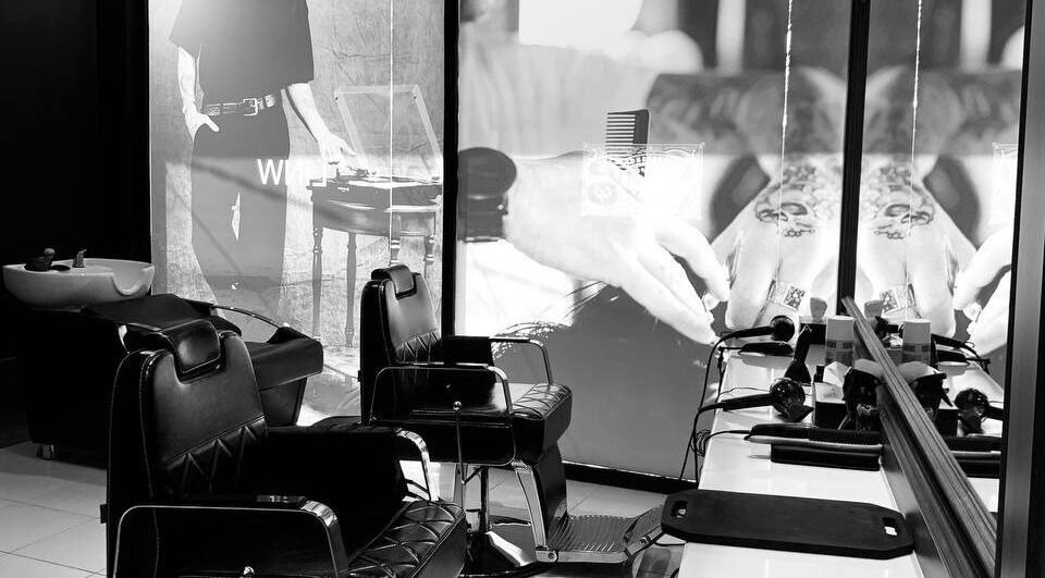 Interior view of Dorsey's Barber Shop at Canggu in Bali, Bali, ID with stylish black chairs.