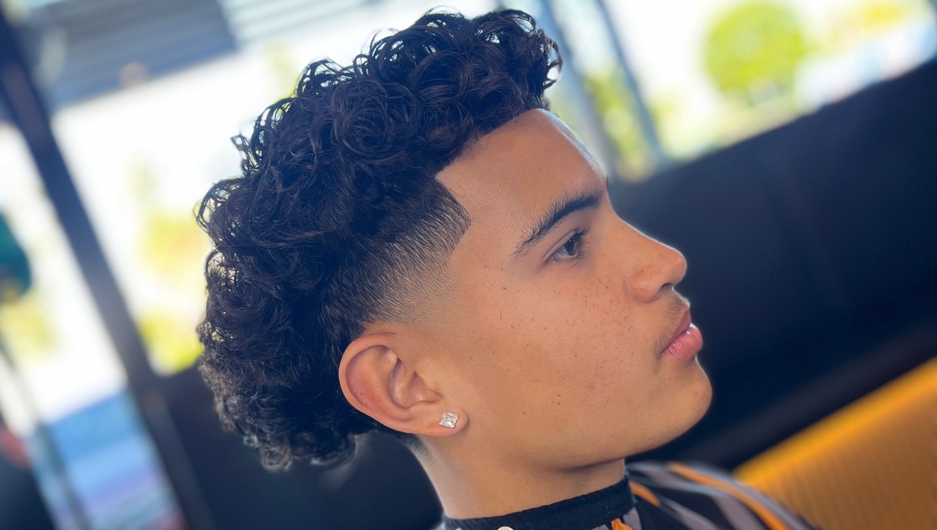 A stylish curl fade haircut at Hitman Barbershop, Yarrabilba, Queensland, AU, showcasing expertise in barbering.