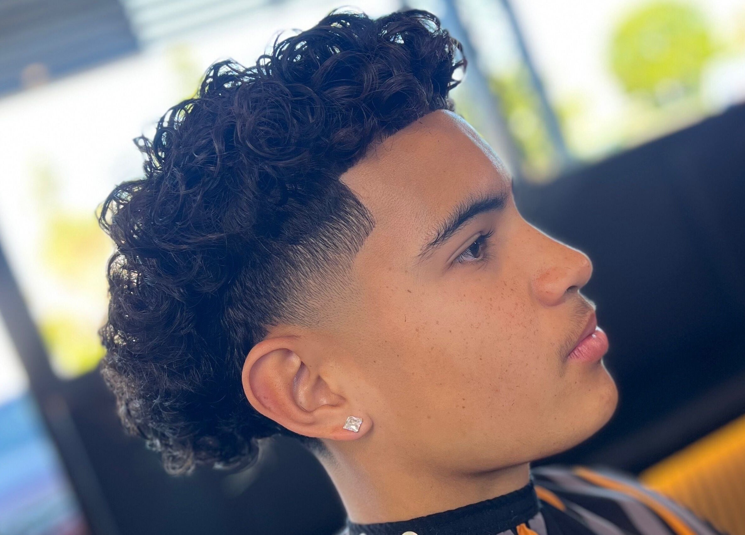 A stylish curl fade haircut at Hitman Barbershop, Yarrabilba, Queensland, AU, showcasing expertise in barbering.