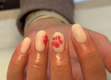 Elegant nail art with red blossoms at Gels By Kayles in Taunton, England, GB.