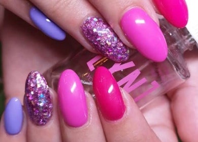 Bright and glittery manicure at Mooi Getooi in Douglas, Northern Cape, ZA featuring vivid pink and purple tones.