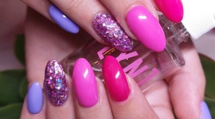 Bright and glittery manicure at Mooi Getooi in Douglas, Northern Cape, ZA featuring vivid pink and purple tones.