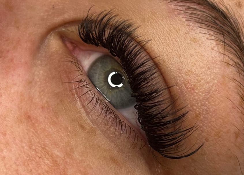 Close-up of eye with lush lashes at Vienna Aesthetics, Reigate, England, GB offering stunning beauty services.