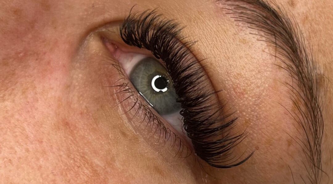 Close-up of eye with lush lashes at Vienna Aesthetics, Reigate, England, GB offering stunning beauty services.