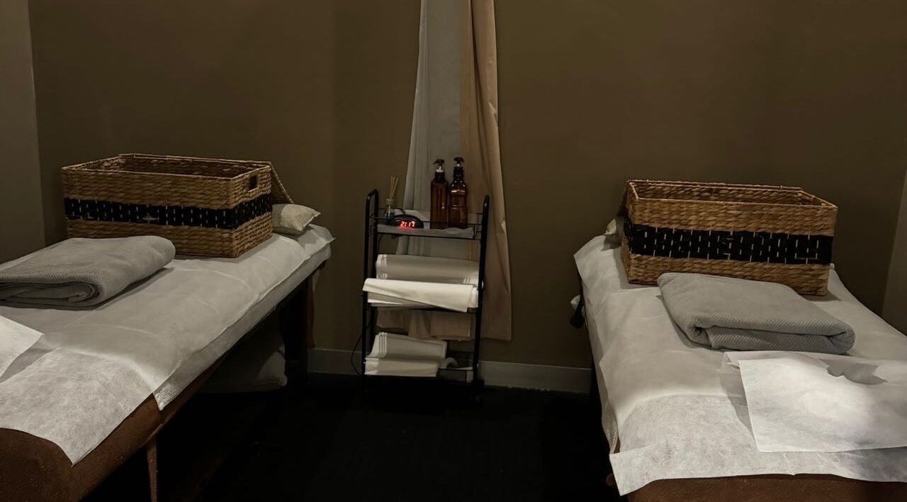 Cozy massage room at Natural 5 Massage & Spa, Melbourne, Victoria, AU, featuring two beds with plush towels.