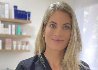 Professional at Studio XO La Lucia, Durban North, Kwazulu-natal, ZA with skincare products in the background.