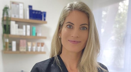 Professional at Studio XO La Lucia, Durban North, Kwazulu-natal, ZA with skincare products in the background.