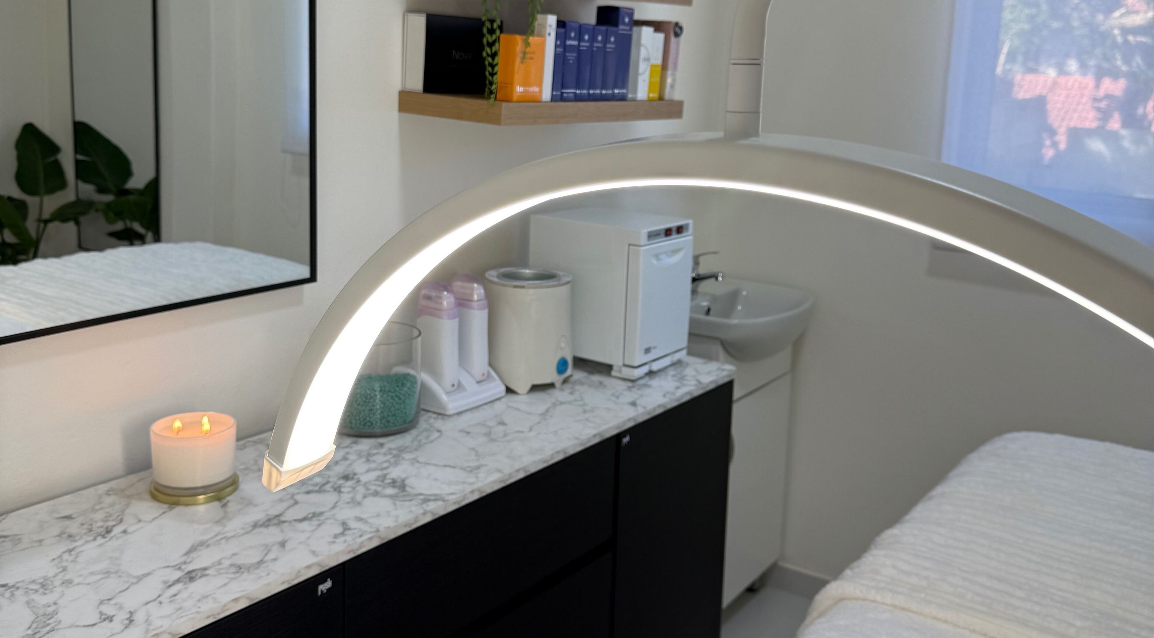 Tranquil treatment room at Studio XO La Lucia, Durban North, featuring modern equipment and candles.