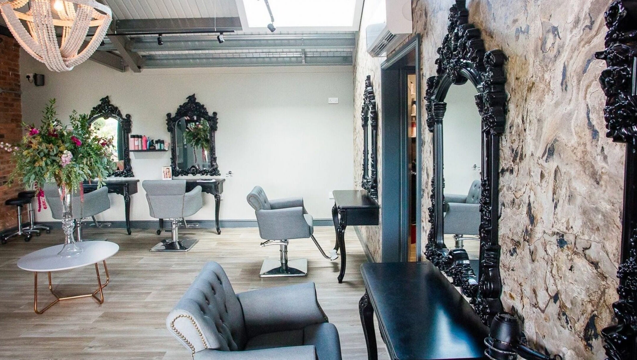 Elegant seating area at The Salon in Tamworth, England, GB with ornate mirrors and floral decor.