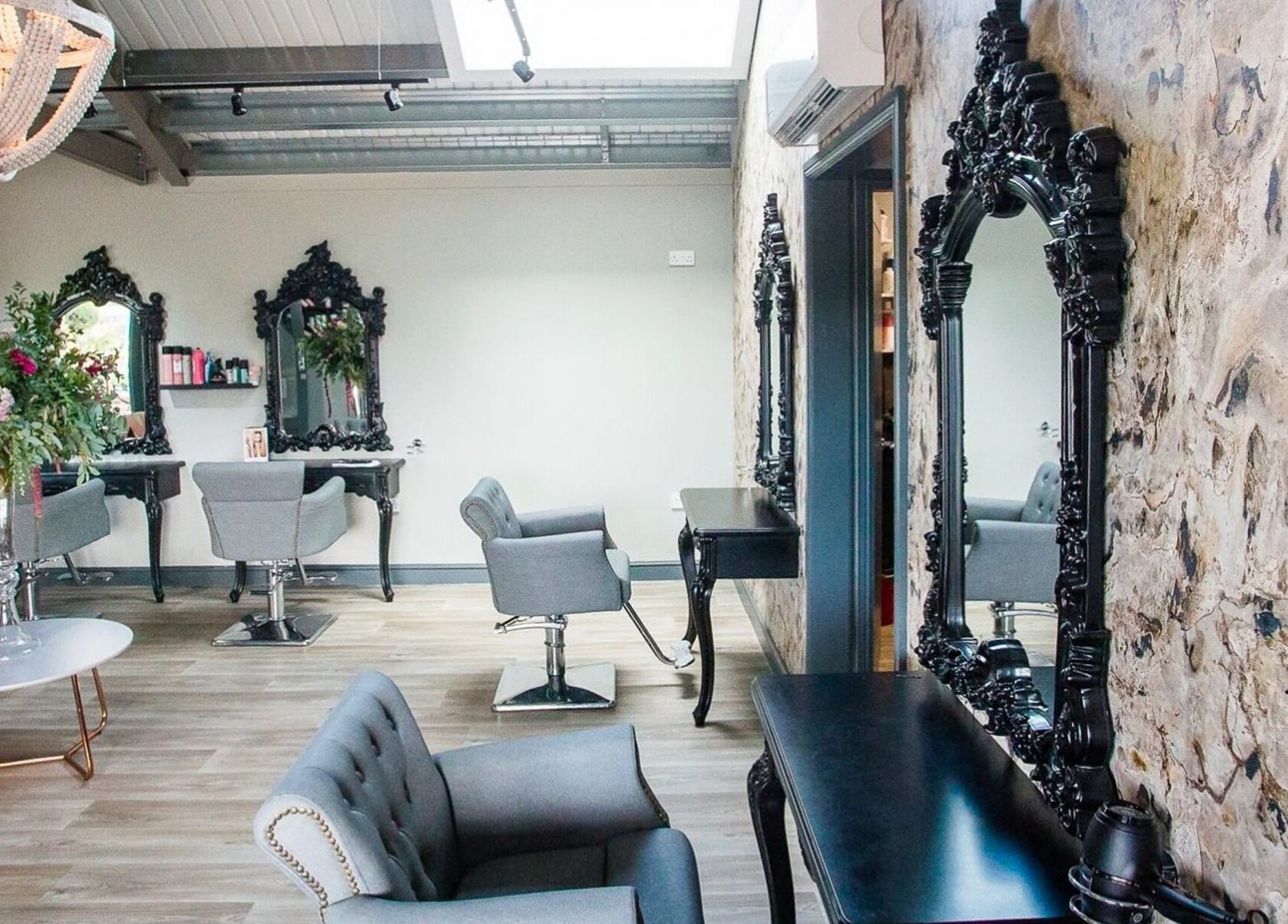 Elegant seating area at The Salon in Tamworth, England, GB with ornate mirrors and floral decor.