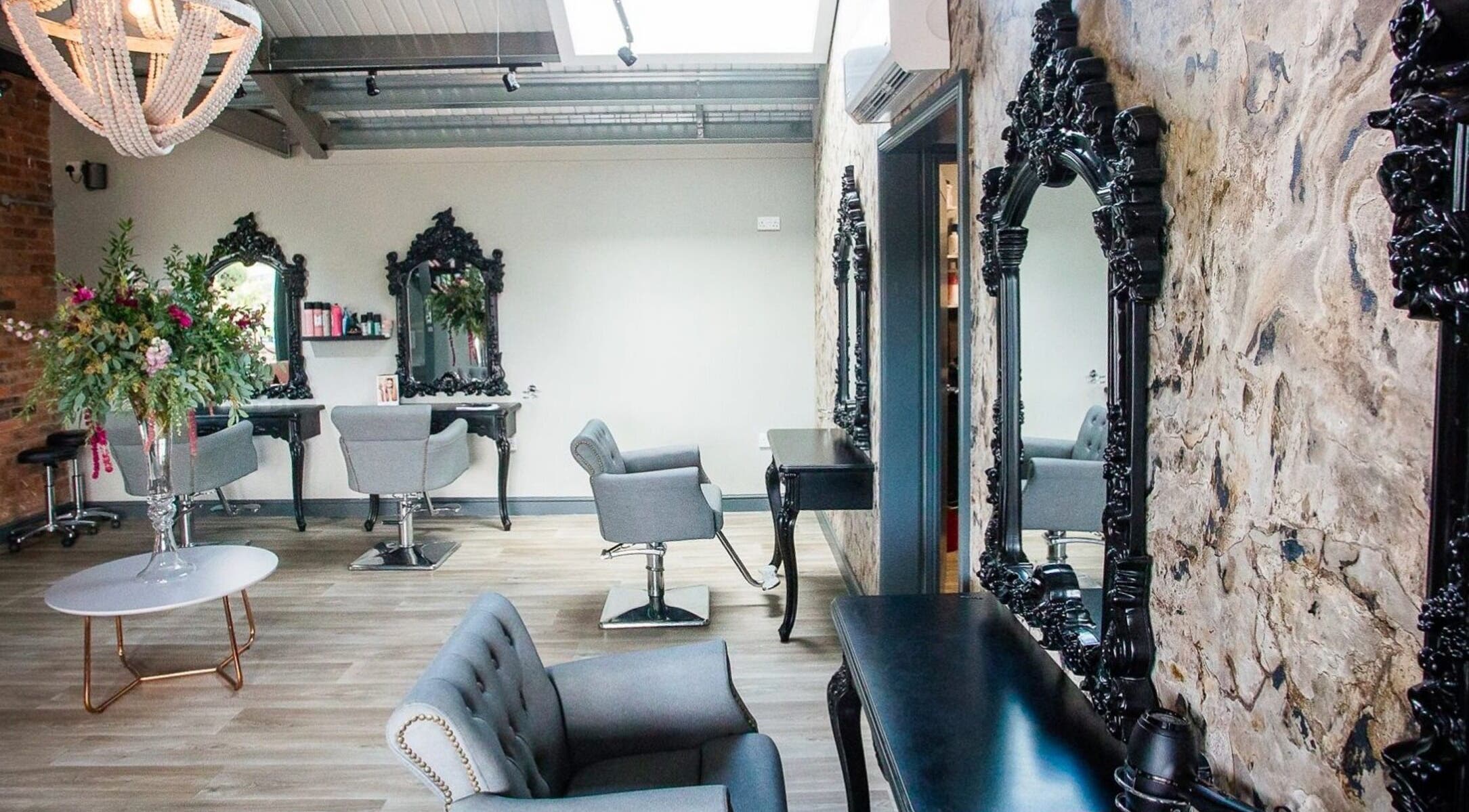 Elegant seating area at The Salon in Tamworth, England, GB with ornate mirrors and floral decor.