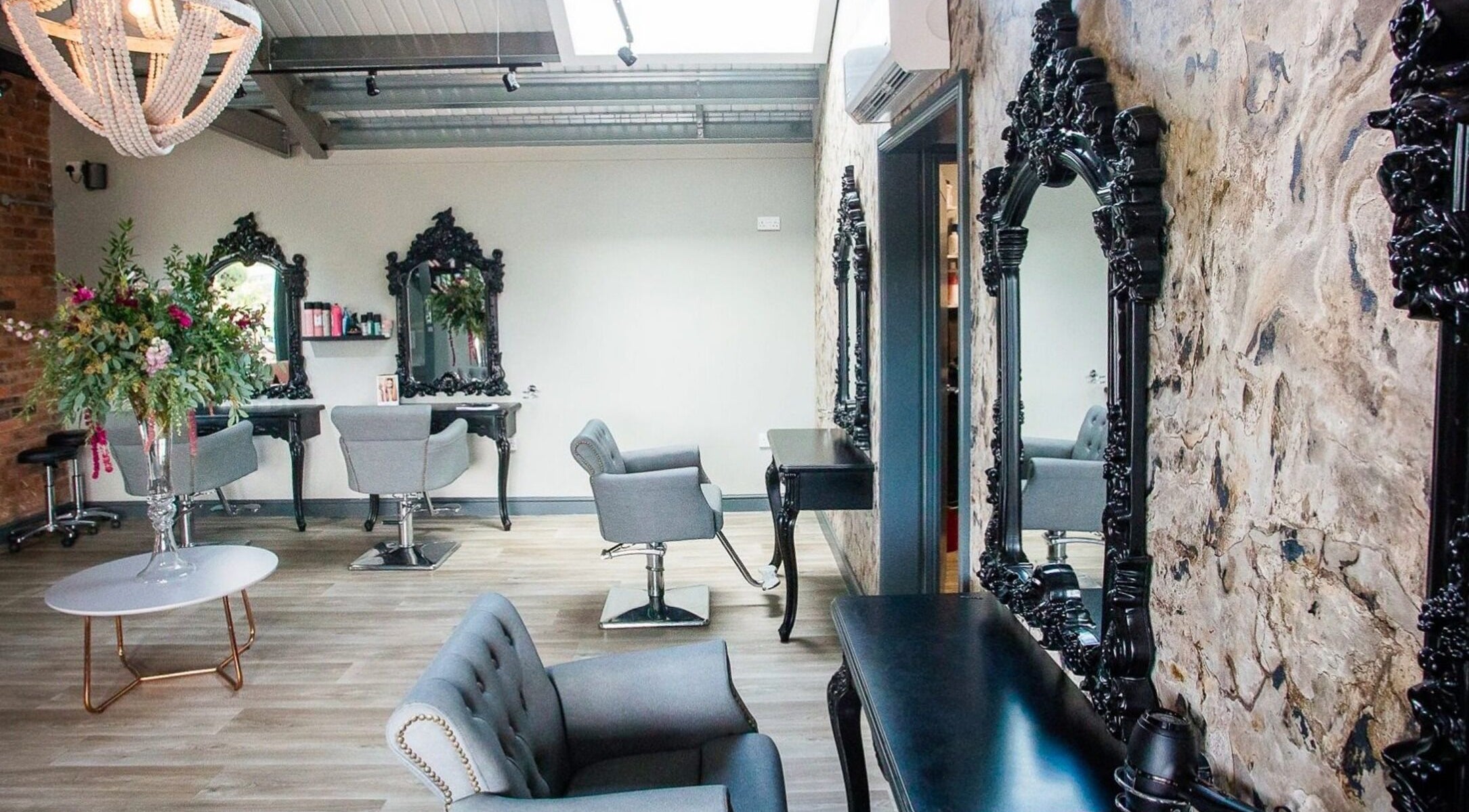 Elegant seating area at The Salon in Tamworth, England, GB with ornate mirrors and floral decor.