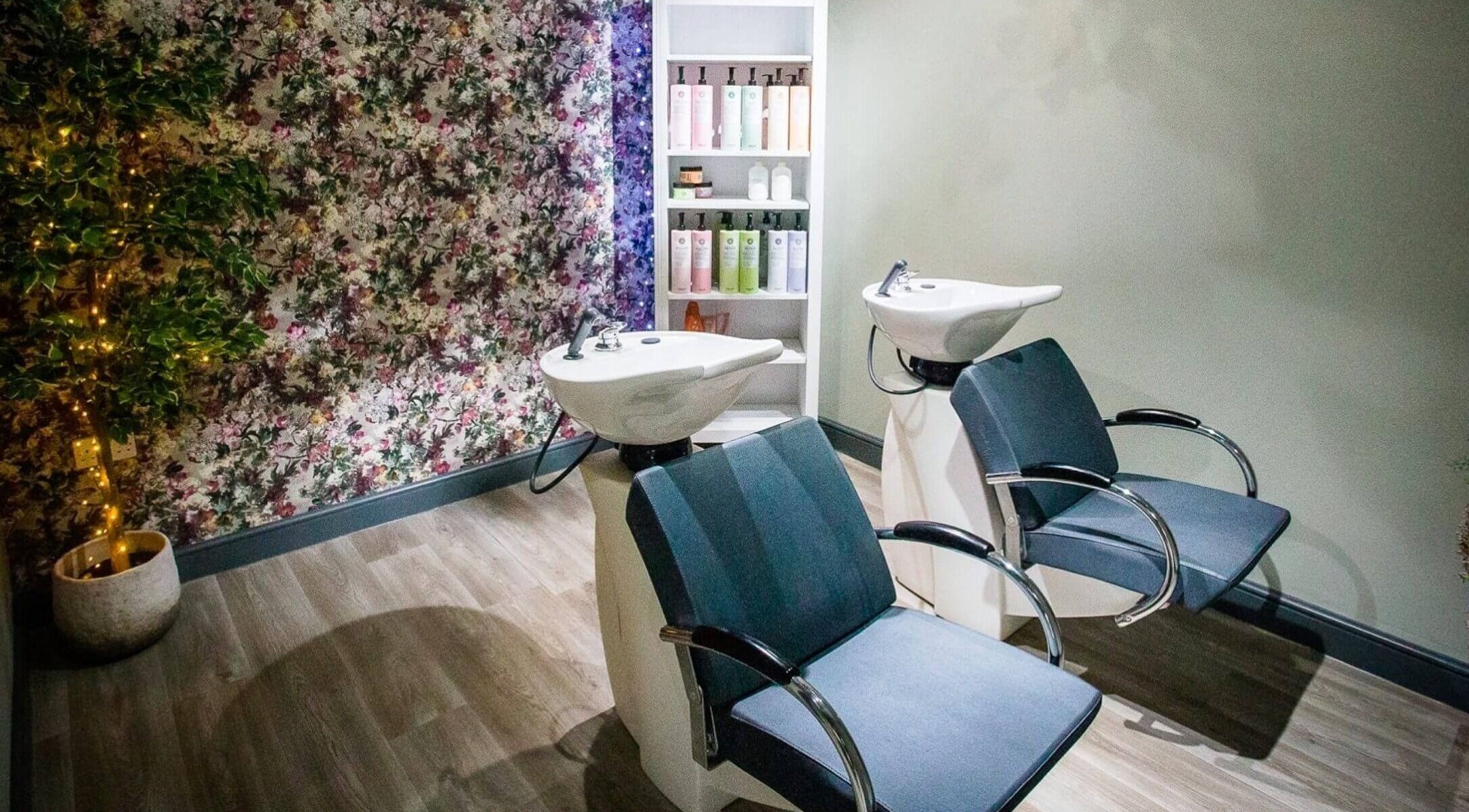 Shampoo stations with floral decor at The Salon, Tamworth, England, GB. Relax in a calming beauty setting.