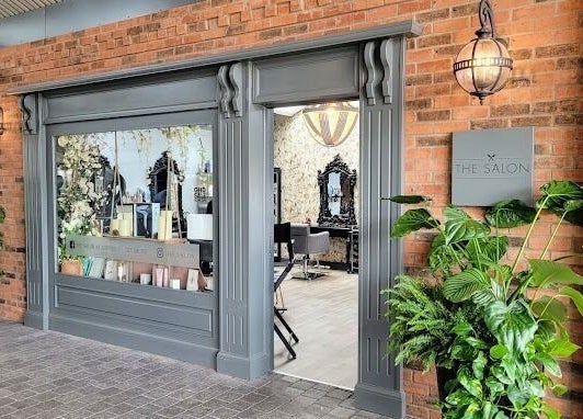 Chic exterior of The Salon in Tamworth, England, GB with stylish decor and lush greenery.