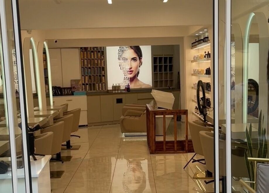 Chic interior of Furkan Yurtbay salon in İstanbul, İstanbul, TR with modern styling chairs and beauty products.
