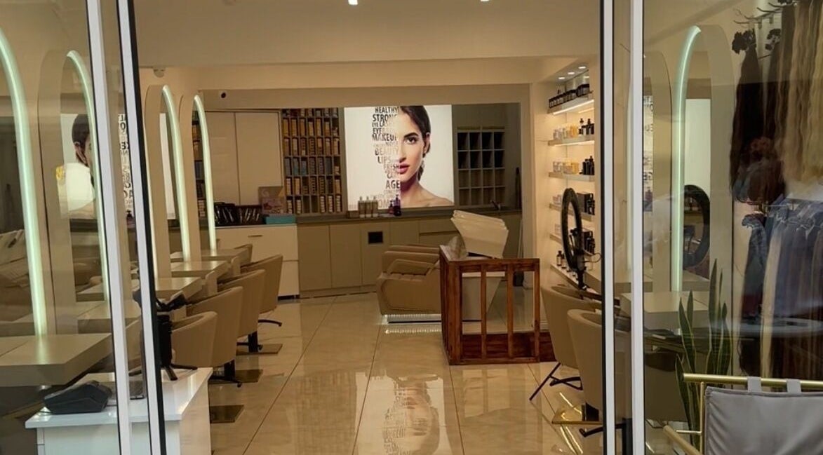 Chic interior of Furkan Yurtbay salon in İstanbul, İstanbul, TR with modern styling chairs and beauty products.