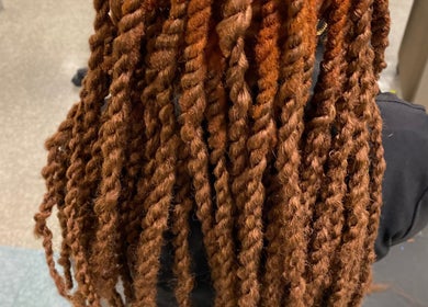 Stylish brown twists hairstyle at Platinum's Beauty Studio in Burlington, North Carolina, US.