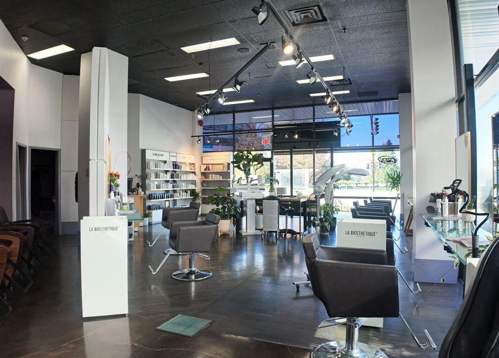 Inside Luxevoir Hair Lounge & Spa, North Vancouver, BC. Modern chairs, bright lighting, serene ambience.