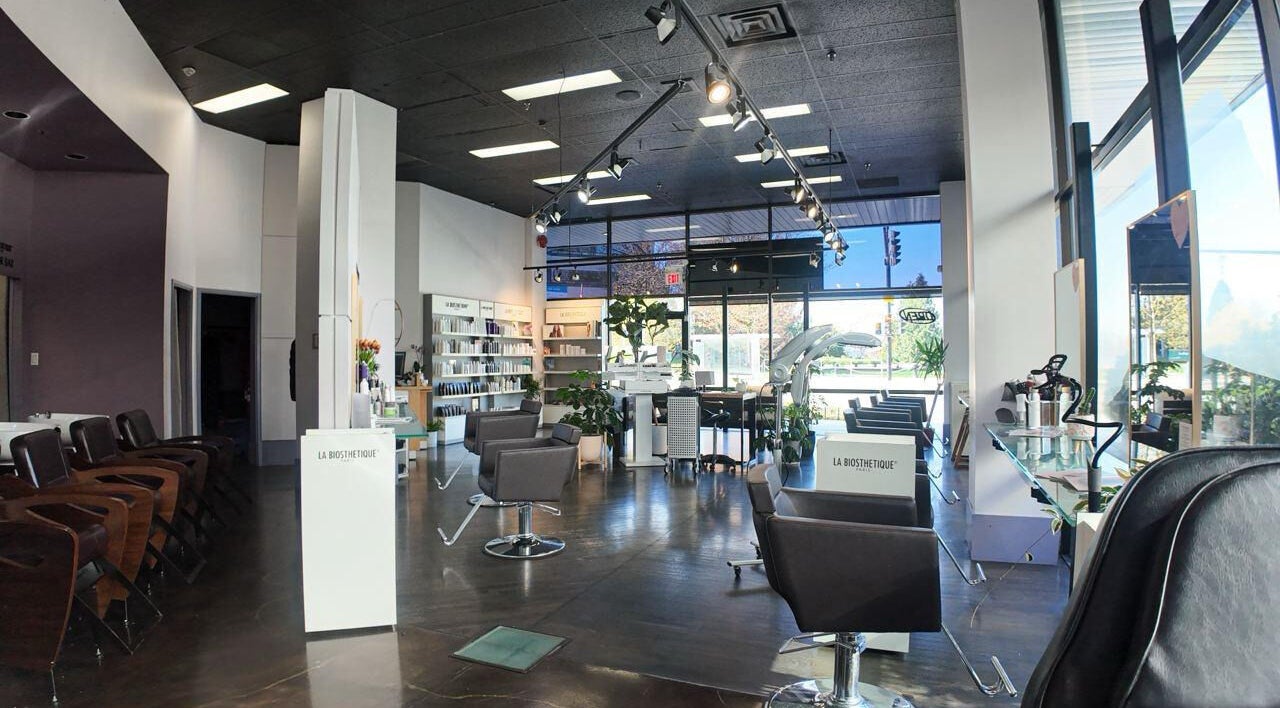 Inside Luxevoir Hair Lounge & Spa, North Vancouver, BC. Modern chairs, bright lighting, serene ambience.