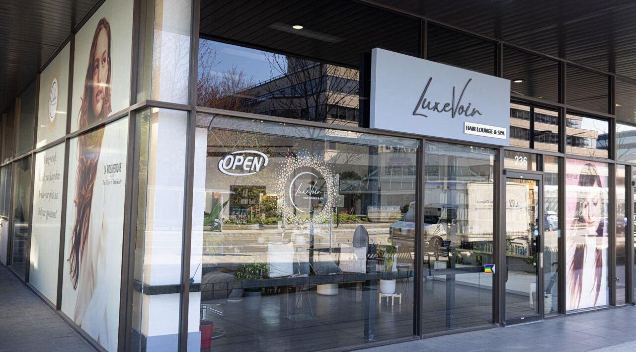 Entrance of Luxevoir Hair Lounge & Spa in North Vancouver, British Columbia, CA with stylish signage.