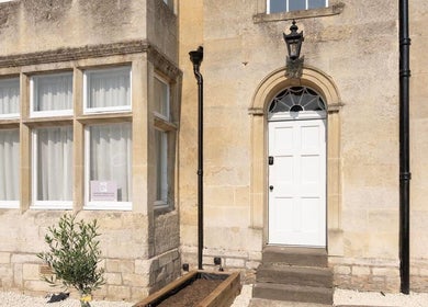 Classic entrance of Aesthetic Medical LTD, Trowbridge, England, GB with stone facade and white door.