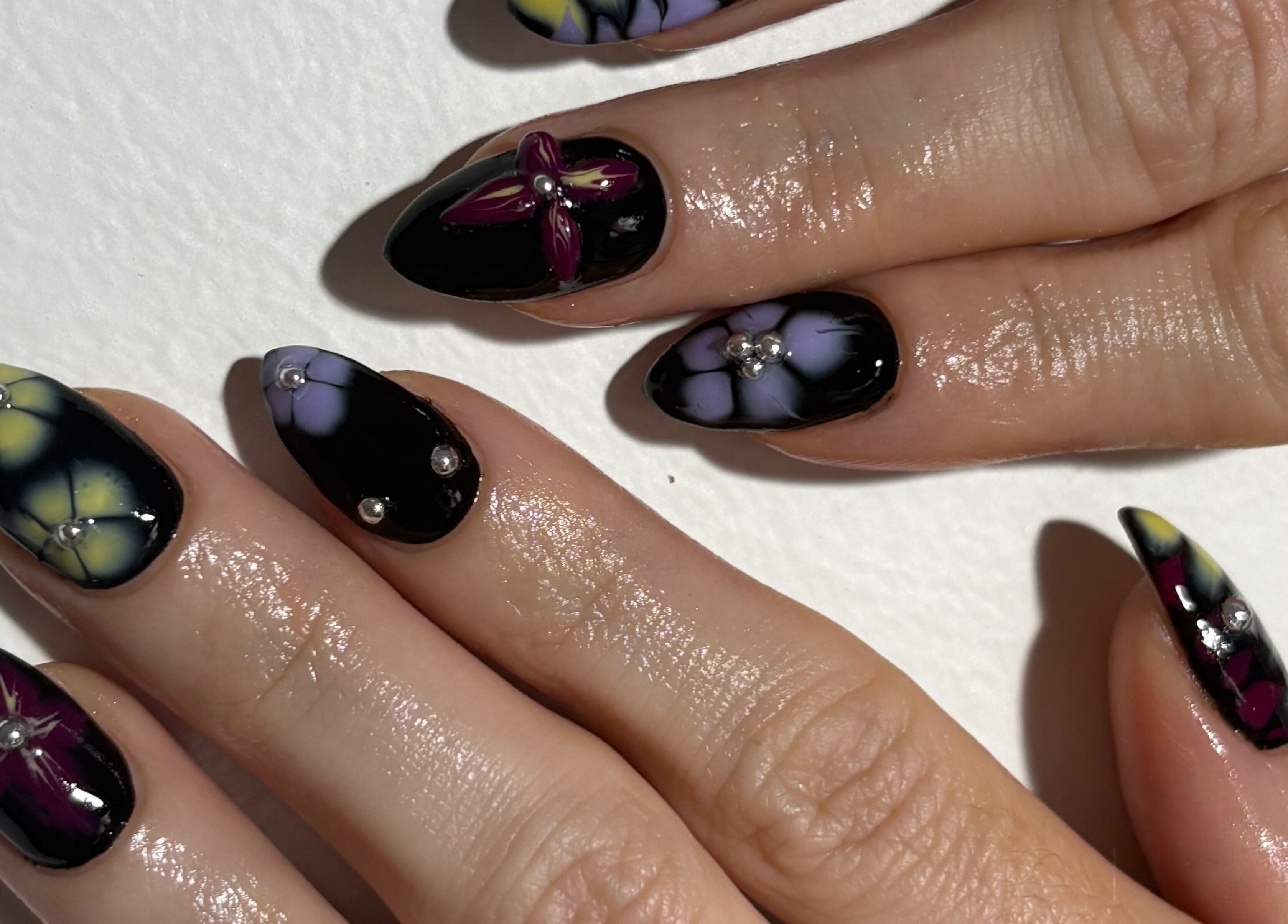 Close-up of floral nail art with gems at Gelalicious Nails, East Victoria Park, Western Australia, AU.