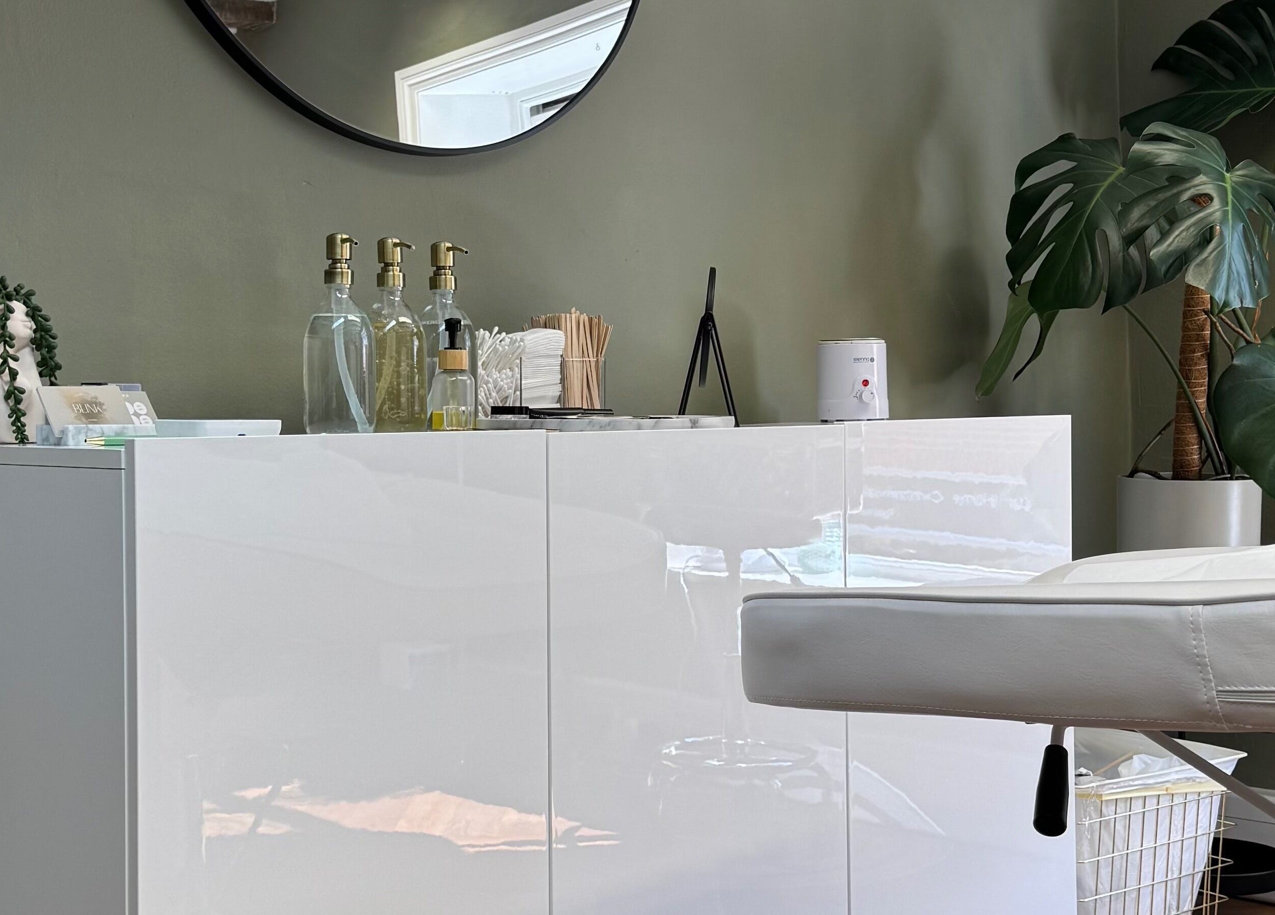 Chic salon interior at BL.INK STUDIO, Dereham, England, GB with lush plants and modern decor.